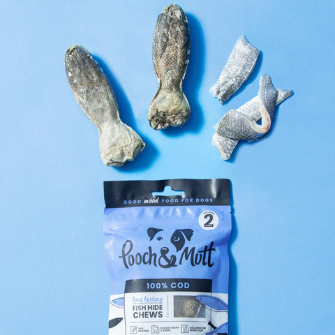 Pooch and mutt long lasting fish chews packet with contents and raw ingredients spilling out