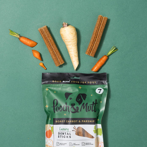 Pooch & Mutt dog treat package with roasted carrot, parsnip, and dental sticks on a green background